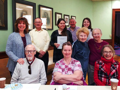 Group of adults sitting and standing for photo